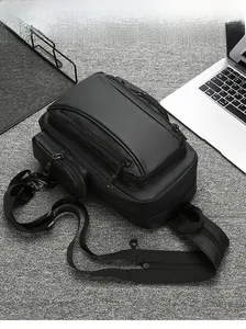 Detailed view of the multi-compartment waterproof black nylon crossbody bag with laptop