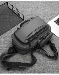 Macro view of water-resistant grey crossbody bag with multiple zippered pockets and strap