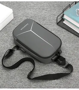 Close-up of a dark grey anti-theft chest bag with a secure side combination lock