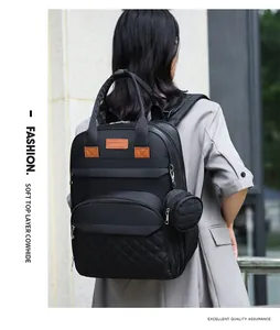 Détail du dos d'un sac à dos à langer noir avec poche matelassée et petit porte-monnaie
