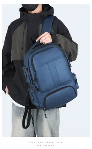 Détail d'un sac à dos d'affaires bleu foncé à compartiments multiples porté par un mannequin