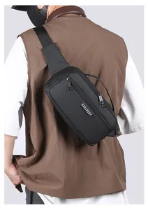 Detailed back view of a black crossbody chest bag with adjustable strap and multiple zippers