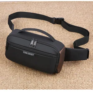Detail view of black nylon sling bag with brown trim and adjustable shoulder strap