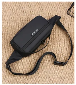 Detail view of the black sports chest bag with a branded logo and adjustable buckle strap