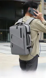 Detail of gray business backpack with USB port and waterproof fabric on a male model