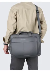 Dark grey business briefcase worn over the shoulder showing actual size and fit on model