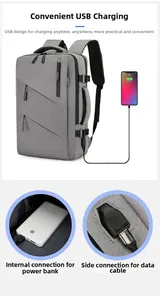 Detail of gray business backpack showing external USB charging port and internal power cable