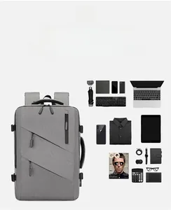 Flat lay of gray business backpack showing organized storage for laptop and tech gear
