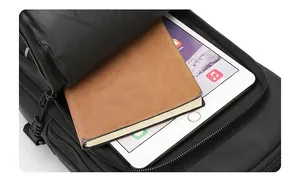 Detail shot of black crossbody bag interior with large capacity for iPad and notebook