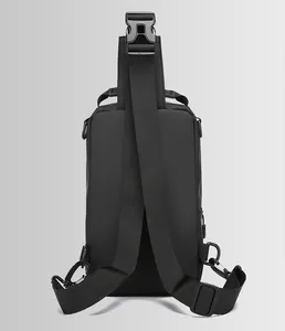 Detail view of the back of a black men's crossbody bag with adjustable wide strap and buckle