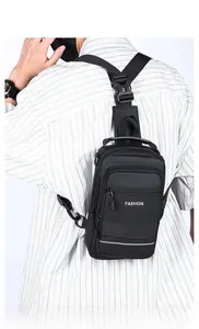 Detail view of the black crossbody bag showing the reflective safety strip and fashion logo