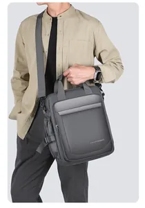 Macro shot of waterproof dark gray men's crossbody bag with adjustable wide strap and buckles