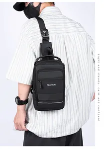 Detail of black waterproof crossbody bag with FASHION lettering and buckle strap
