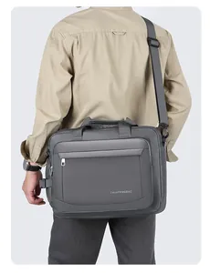 Close-up of premium waterproof fabric and reinforced handle on the gray business briefcase