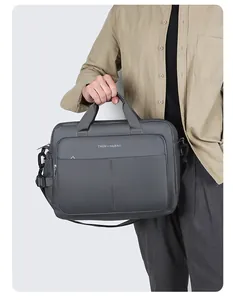 Detail of grey nylon business briefcase showing front zipper pocket and reinforced handles