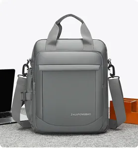 Close-up of a grey waterproof nylon briefcase with reinforced handles and brand logo