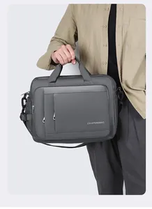 Close-up of a dark grey business laptop bag with reinforced handles and metal D-rings