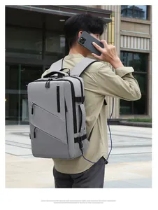 Detail of grey business backpack showing USB charging port and durable fabric texture