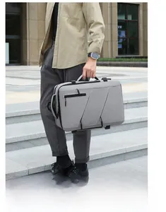 Gray business backpack with durable fabric and zipper details on outdoor stairs