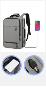 Detail view of the external USB charging port and power bank connection on gray backpack