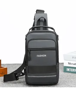 Detail view of water-resistant gray crossbody bag with fashion text and reflective stripe