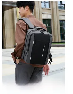 Business casual laptop backpack in grey and black worn by a male model for commute