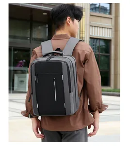 Detail of grey fabric business laptop backpack featuring reflective zipper and side handle