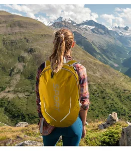 Close-up of yellow hiking backpack with SPORT logo and honeycomb texture on mountains