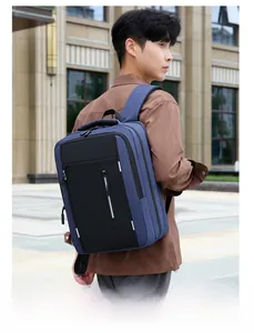 Male model wearing blue and black business casual backpack in a modern city setting