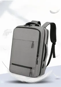 Detail of light grey business backpack showing USB charging port and waterproof texture
