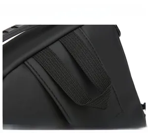 Detail of a flexible reinforced handle on black business crossbody bag with sturdy stitching