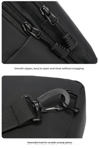 Detail of smooth double zippers and detachable swivel hook on black crossbody bag