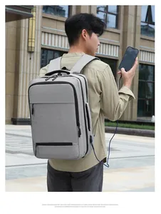 Detail of grey business laptop backpack featuring external USB charging port and fabric texture