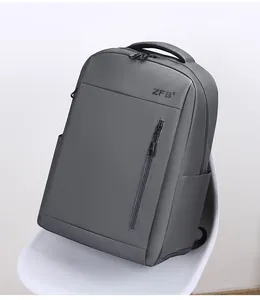 Detail of waterproof textured grey travel backpack on a chair with logo and metal zippers