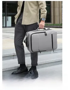 Outdoor shot of a gray multi-functional business backpack with a durable handle and zippers