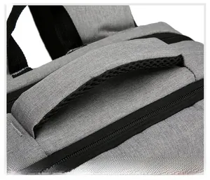 Detailed close-up of the breathable padded handle on a gray travel laptop backpack