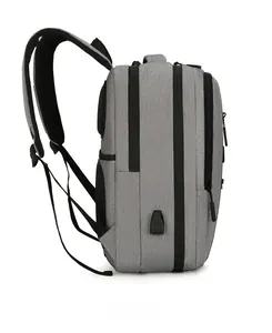 Side view of gray travel backpack with USB charging port and breathable mesh back