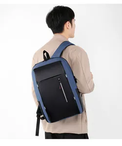 Detail of blue and black business laptop backpack with vertical front zipper on male model