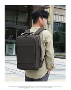Detail view of large dark brown business backpack with side handle and ergonomic straps