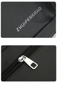 Detailed view of silver metallic zipper and embossed logo on black business briefcase