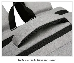 Close-up of the reinforced grey fabric top handle with breathable black mesh padding