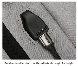 Close-up of gray business backpack shoulder strap with USB port and adjustable buckle