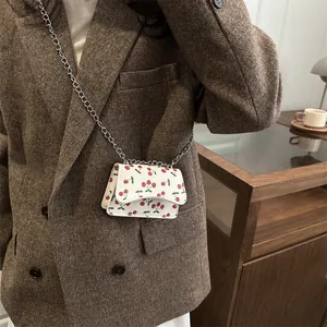 Chic mini white leather crossbody bag with cherry print and silver chain strap