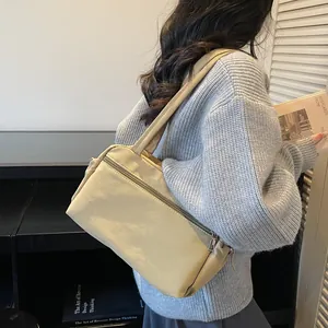 Minimalist beige nylon tote bag with multiple pockets for daily commuting and office use