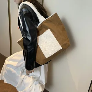 Brown canvas tote bag with white faux shearling pocket for winter fashion styling