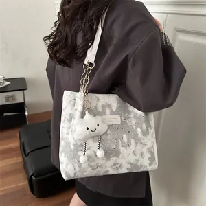 Canvas tote bag with celestial star patterns and cute plush cloud charm for daily commute