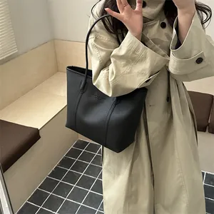 Minimalist black pebble leather tote bag for women with dual shoulder straps for daily commute