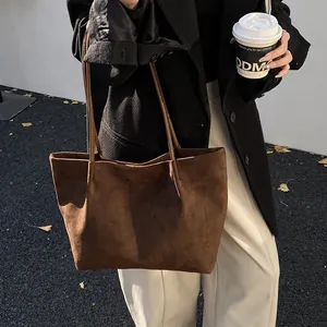 Minimalist large brown matte suede tote bag for women featuring a sleek hobo shoulder design