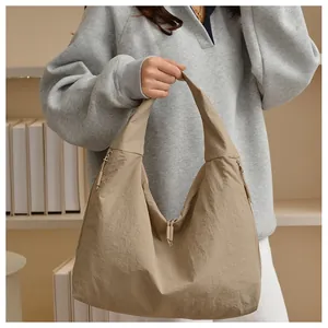 Detail of khaki hobo shoulder bag with zipper closure and soft wrinkled texture fabric