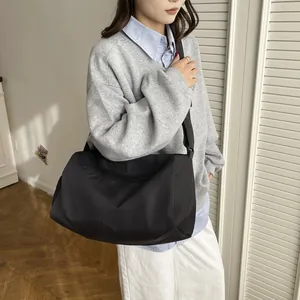 Large capacity black sports bag in waterproof nylon fabric with adjustable shoulder strap